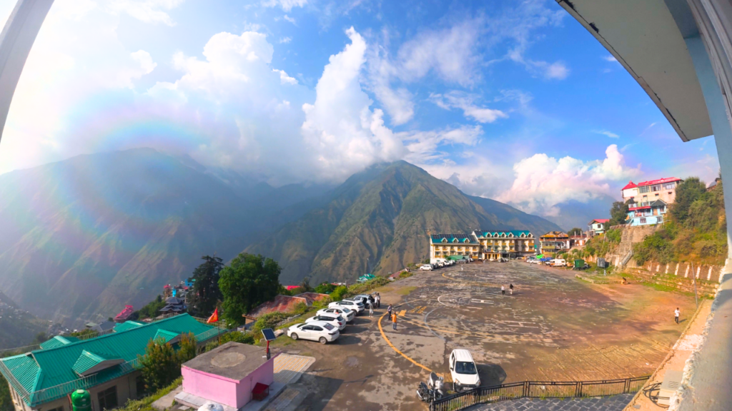 A majestic mountain peak rising into a bright blue sky filled with soft white clouds_